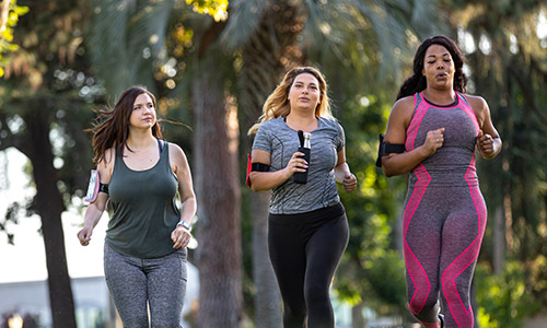 Three women outside jogging